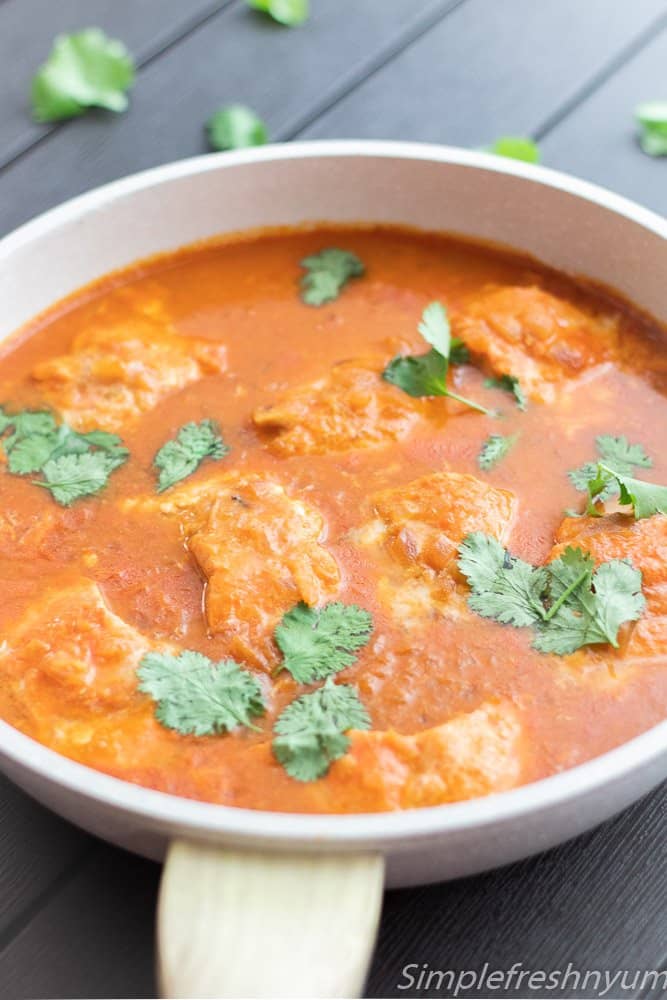 Tomato coconut salmon curry cooked in a pan ready to serve.