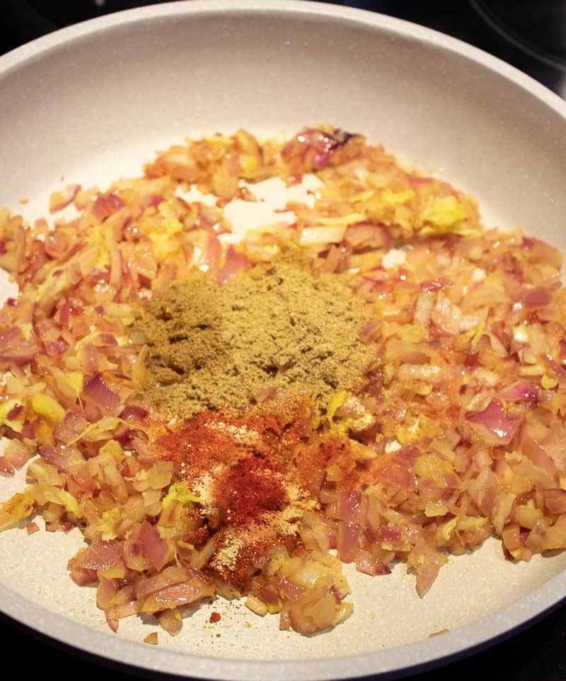 Added coriander, cumin and chilli powders to the golden fried onions in a pan.