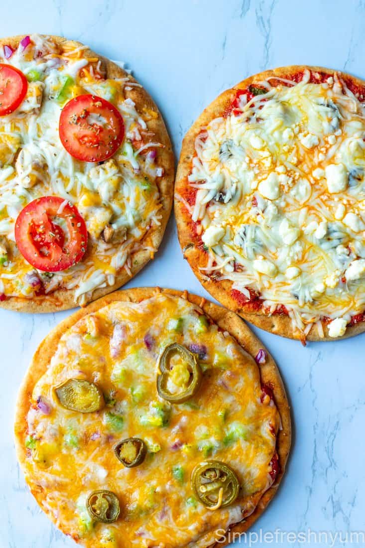 3 Pita bread pizzas ready to eat on a white back drop