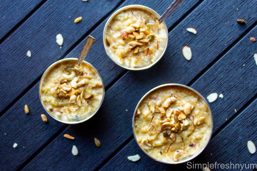 Rice payasam or Rice kheer ready to eat in 3 silver color serving bowls with nuts garnished on top.