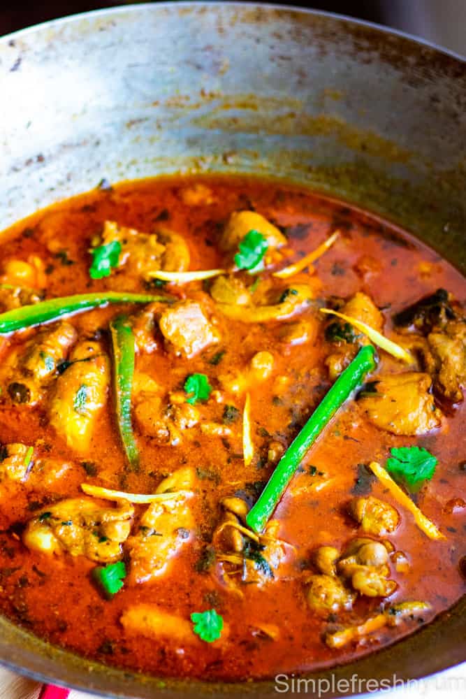 Chicken Karahi finished in a Wok and garnished by thinly sliced jalapenos and ginger juliennes