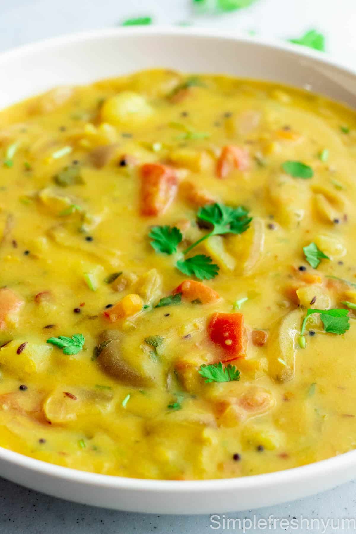 Close up Image of Bombay Chutney served in a white serving plate with cilantro garnished on top