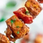 Air fryer grilled Paneer and bell peppers on a skewer with cilantro garnished on top.